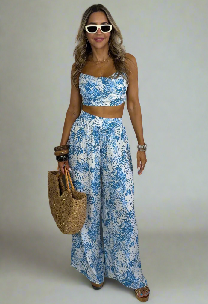 Woman wearing a blue floral outfit with a white background