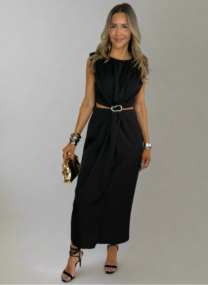 Woman wearing a black dress with a belt, standing on a white background