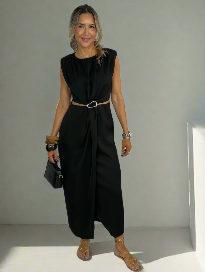 Woman wearing a black sleeveless jumpsuit on a white background