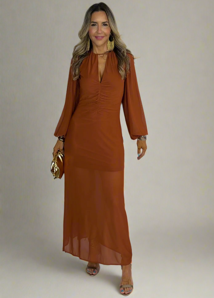 Woman wearing a brown dress against a white background