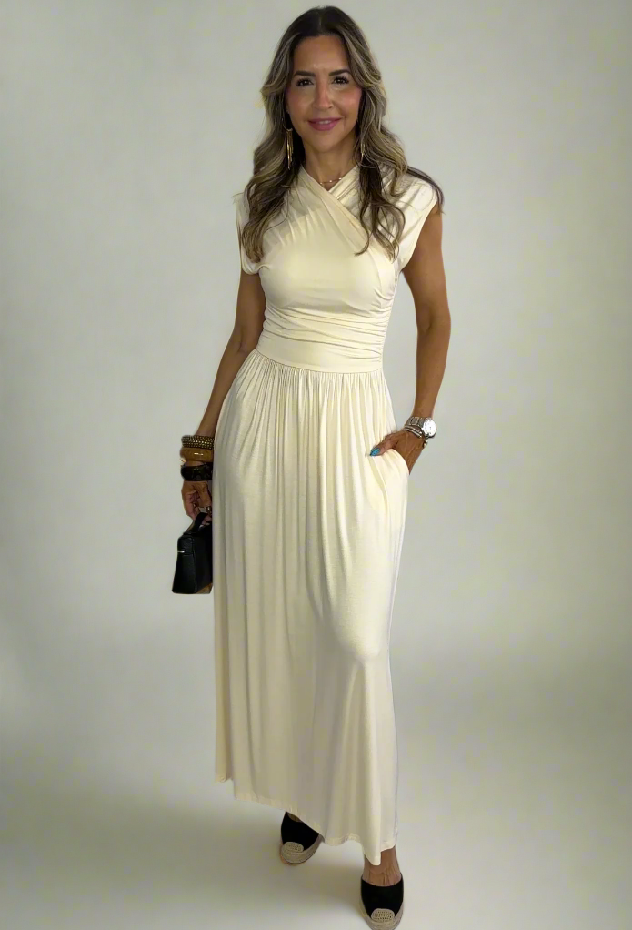 Woman wearing a long white dress against a white background