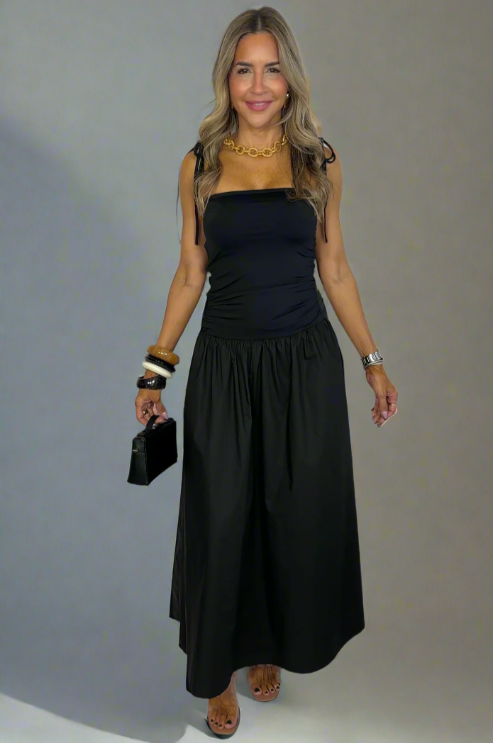 Woman wearing a black dress against a white background