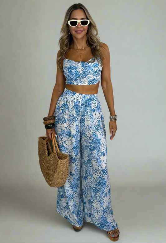 Woman wearing a blue floral outfit with a white background