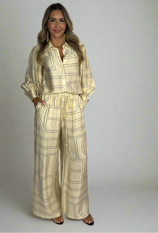 Woman wearing a yellow checkered outfit against a white background
