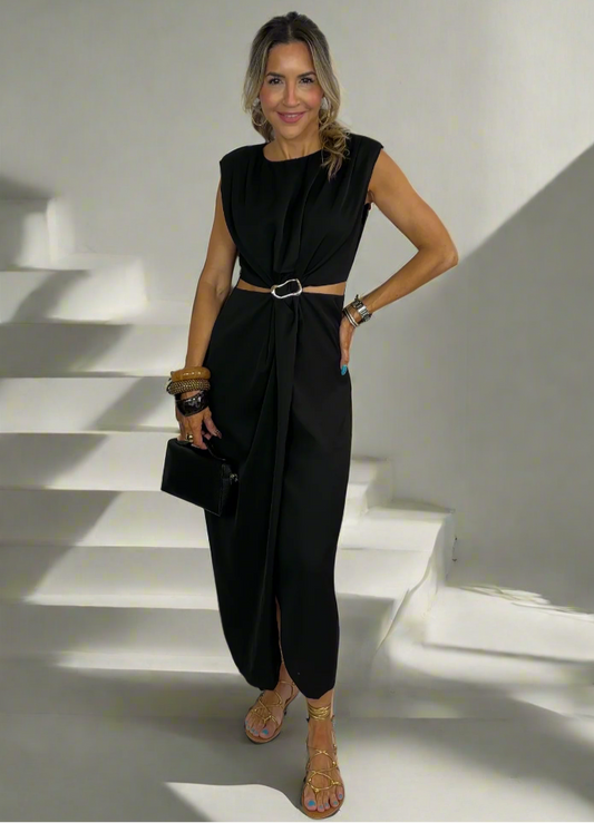 Woman wearing a black sleeveless jumpsuit on a white background