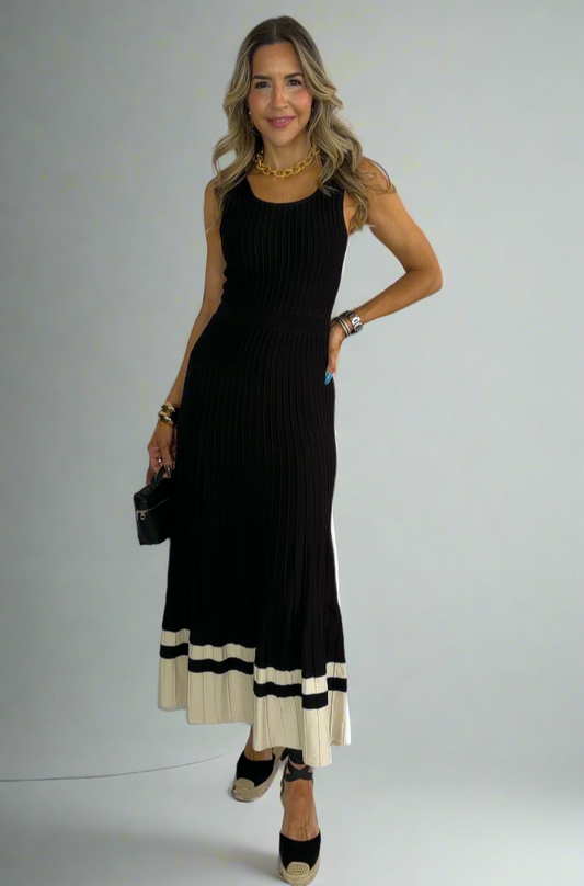 Woman wearing a black and white dress against a white background