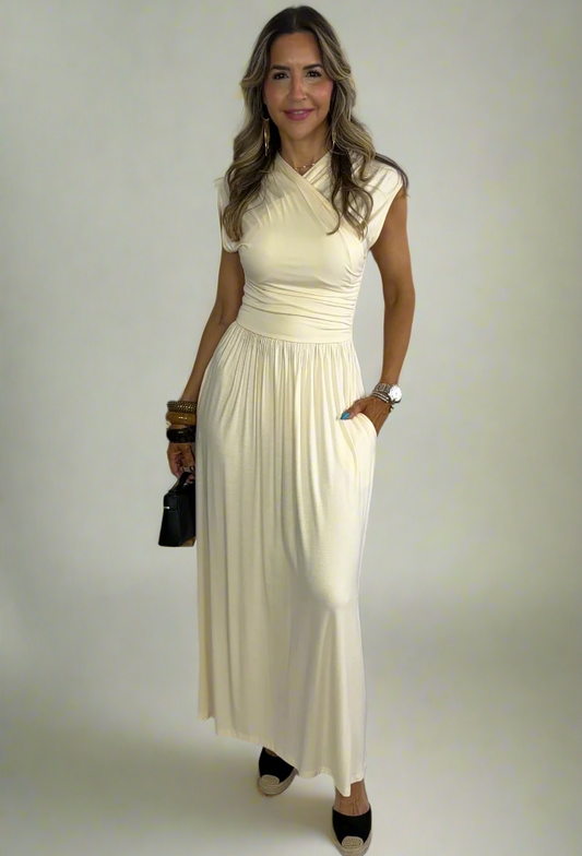 Woman wearing a long white dress against a white background