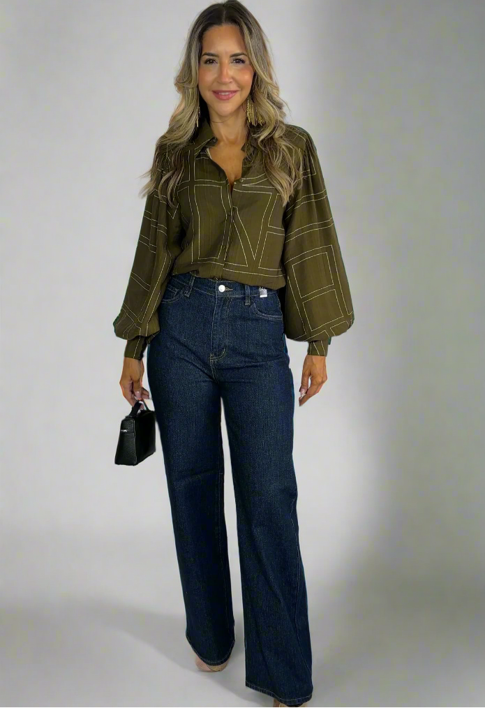 Person wearing a green plaid shirt and blue jeans on a white background