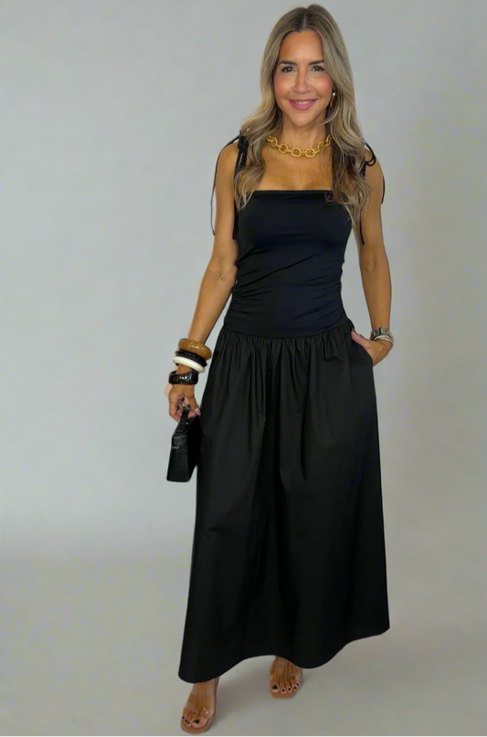 Woman wearing a black dress against a white background